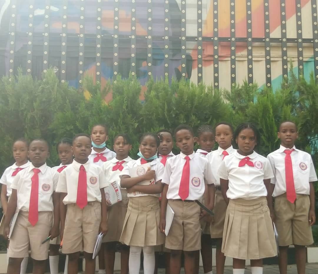 A class photographed together in uniform in the school grounds