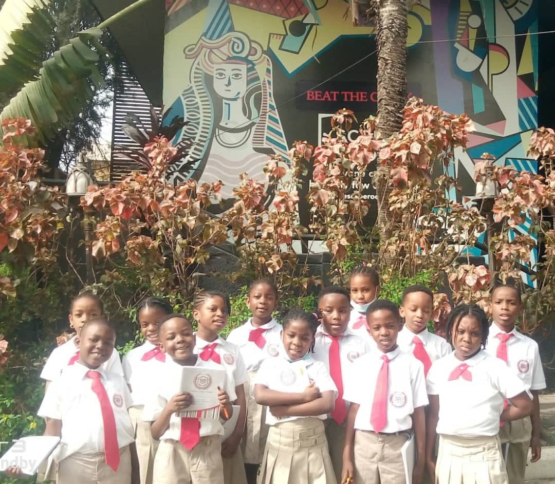 Pupils gathered in front of a painted mural on an excursion