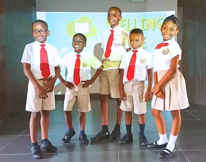 Five pupils representing the school at a spelling competition