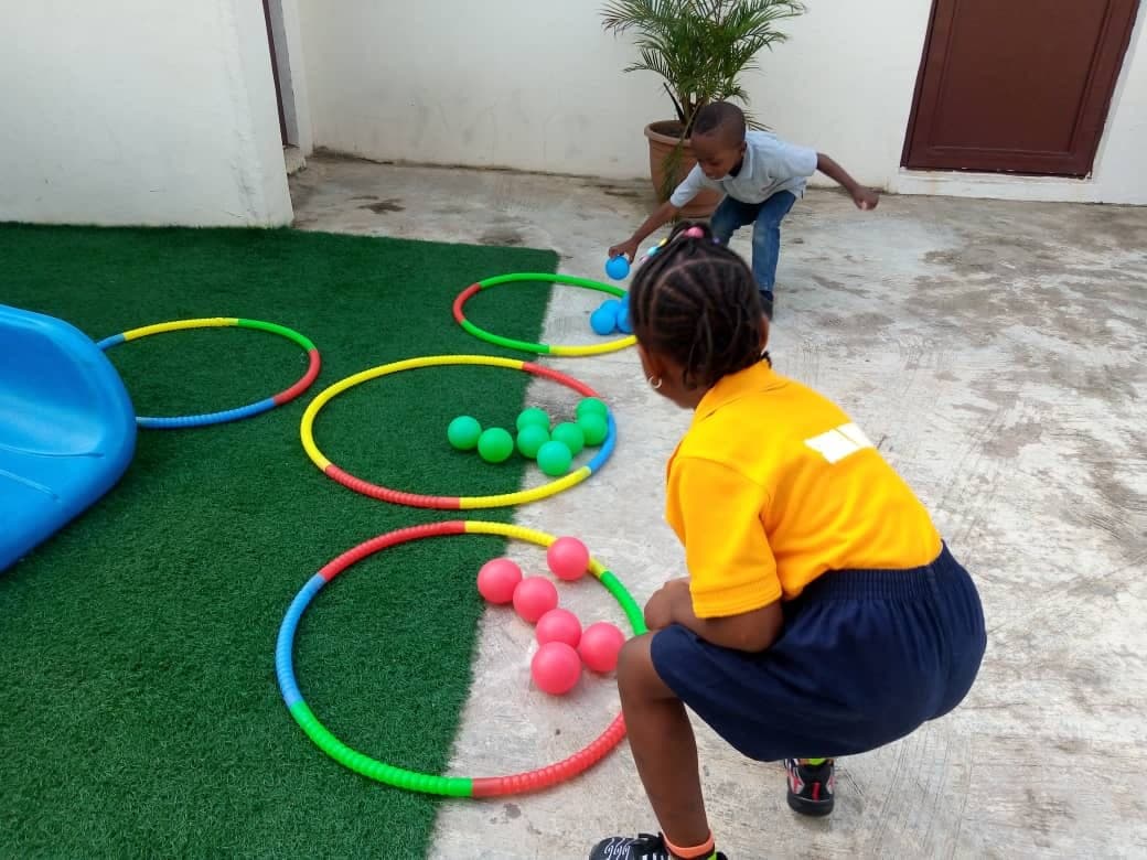 Children setting out hoops and balls for a PE activity